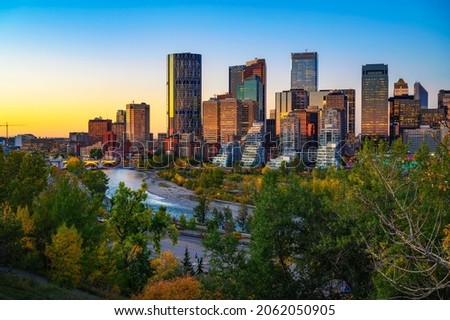 Sunset above city skyline of Calgary with Bow River, Alberta, Canada. Royalty-Free Stock Photo #2062050905