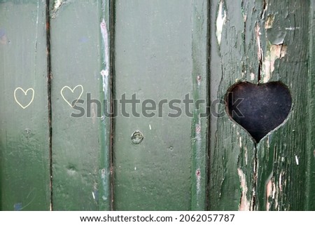 green wood window with heart symbol