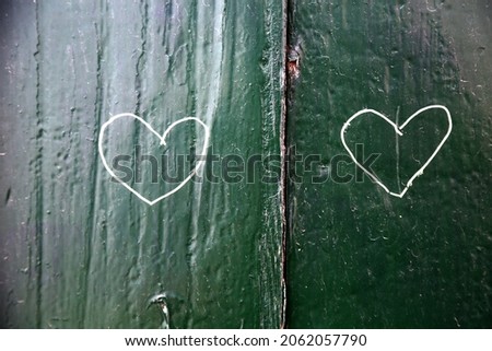 green wood window with heart symbol