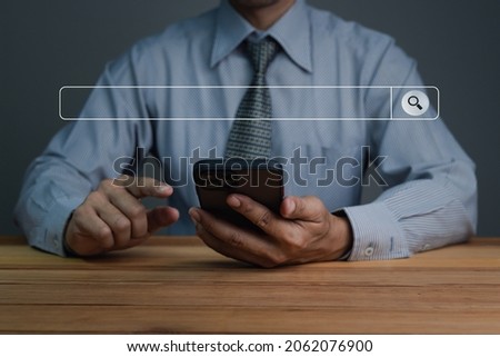 Data Search Technology Search Engine Optimization. Businessman's hands are using a smartphone to Searching for information. Using Search Console with your website.