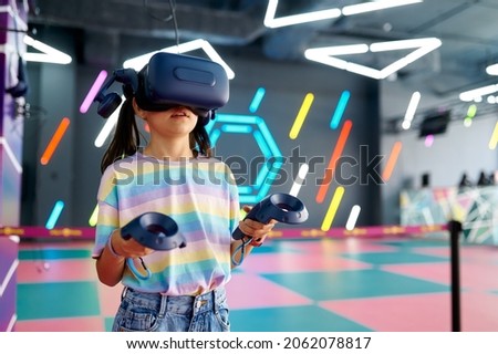 Little girl in virtual reality glasses, playground Royalty-Free Stock Photo #2062078817