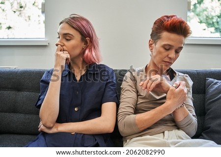 Resentful lesbian females acting like arguing couple and not speaking to each other Royalty-Free Stock Photo #2062082990