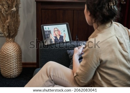 Woman psychologist sitting at casual home office and helping online to her patient Royalty-Free Stock Photo #2062083041