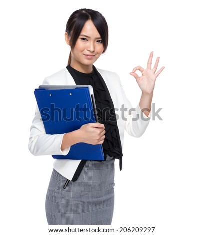 Asian business woman holding chip board with ok sign on white background