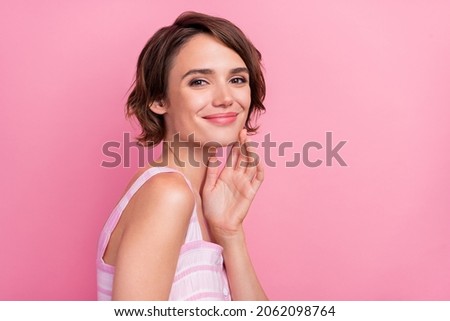 Profile side photo of young lovely lady arm touch cheek enjoy clean soft hydrated skin isolated over pink color background