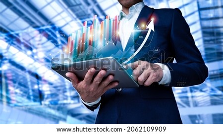 A businessman examines sales statistics and a 3D graph of economic progress. This is a business strategy. Icon that is abstract. Digital marketing is a term that refers to the use of