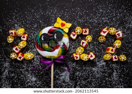 Numbers 2022 from candies. Conceptual photography. Diet. Banner. Business. New Year. Black background.