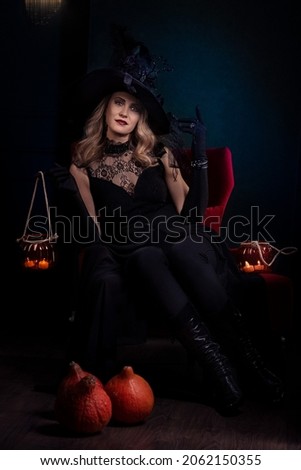 full length portrait of beautiful woman in black witch halloween costume  