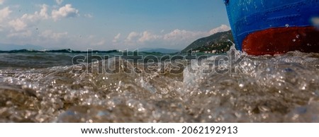 Waves hit the boat on the lake shore, underwater