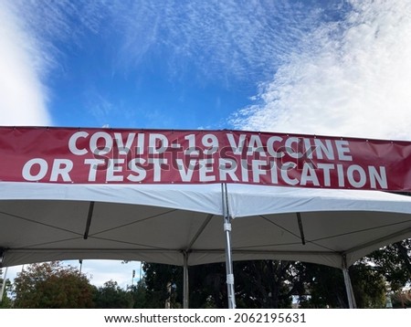 Covid-19 Vaccine or Test Verification sign on the banner above the entrance to public event, concert or stadium