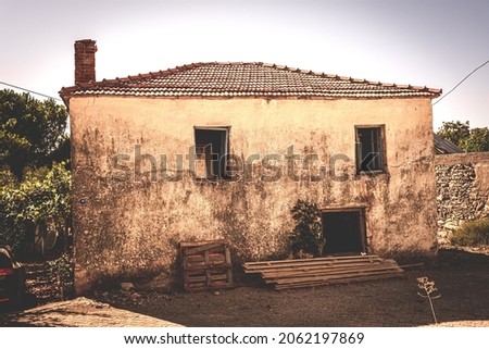 Single storey village home under white clear sky in Barbaros, Izmir, Turkey. Old style photo with sepia tones of a single storey village house.