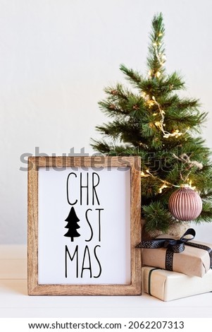 Christmas background with wooden picture frame with text christmas and decoration. Winter holidays celebration concept with copy space for text. 