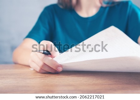 woman taking notes in papers
