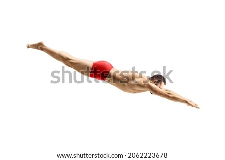 Male swimmer in a red swimsuit jumping to dive isolated on white background Royalty-Free Stock Photo #2062223678