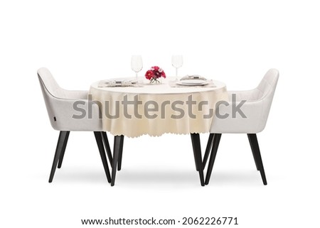 Round restaurant table with a cloth set for two persons isolated on white background Royalty-Free Stock Photo #2062226771