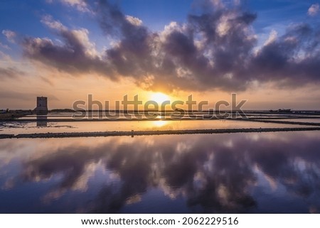 Sunset over Saline di Nubia - saltworks in Nubia village near Trapani city, Sicily Island in Italy Royalty-Free Stock Photo #2062229516