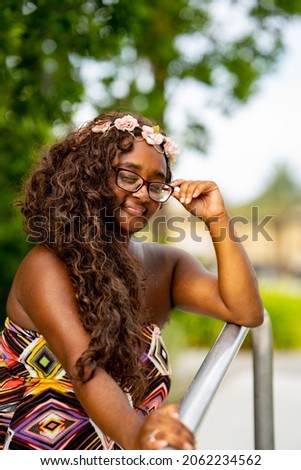 Beautiful young multiracial female model posing in a colorful dress at a tropical setting Royalty-Free Stock Photo #2062234562