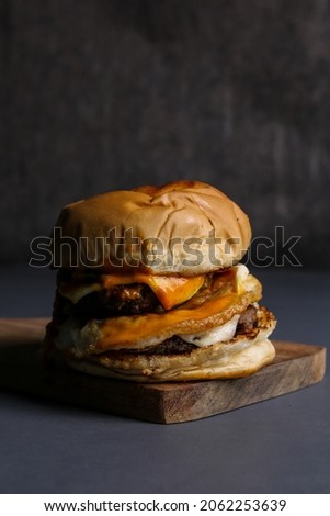 fresh tasty burger on wooden cutting board