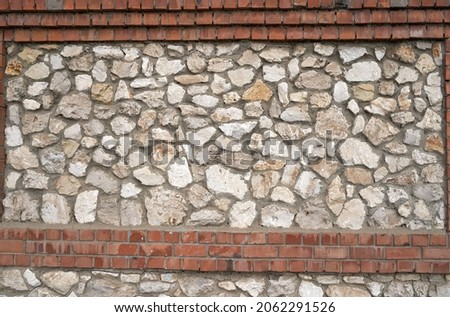    Old brick wall, old texture of red stone blocks closeup                            