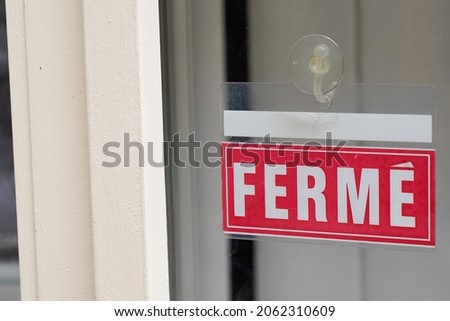 ferme means in french closed on text sign board red on windows shop restaurant cafe store signboard