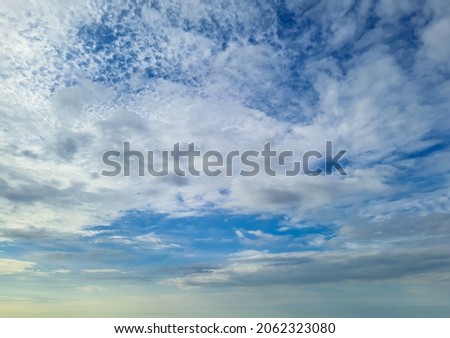 bright blue sky with white cloud patches at morning