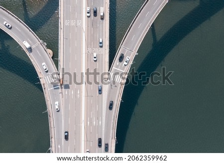 Road junction and bridge on river in the city, aerial view.