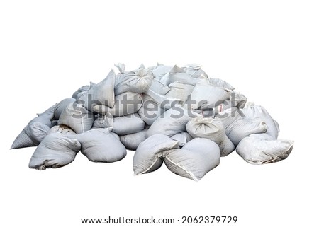 The piles of white sandbags were piled on top of each other all over the floor. huge pile of sand bags. Isolated Royalty-Free Stock Photo #2062379729