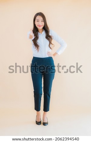 Portrait beautiful young asian business woman in action on isolated color background