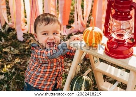 Happy little child holding pumpkin. trick or treat. Funny children. Adorable boy playing in autumn park with sweet autumn decoration. Child celebrating Thanksgiving. Fall season decoration. halloween