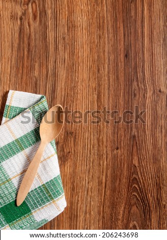 wooden spoon on a towel in the green square on the white background