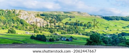 A panorama view over farmland in the River Ribble Valley near Settle, Yorkshire in summertime Royalty-Free Stock Photo #2062447667