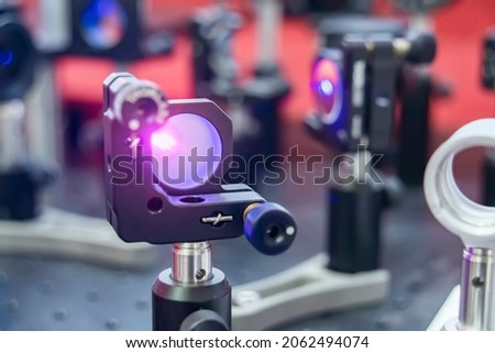 Experiment with laser device in optical laboratory Royalty-Free Stock Photo #2062494074