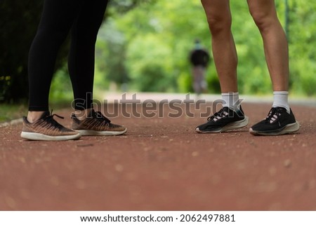 Close up picture of running shoes on red track for running