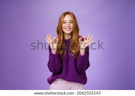 Girl loves her new haircut showing okay gesture with both hands and smiling delighted, feeling happy and satisfied, posing in purple outfit over violet background pleased with perfect customer service