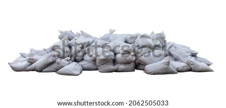 The piles of white sandbags were piled on top of each other all over the floor. huge pile of sand bags. Isolated. Royalty-Free Stock Photo #2062505033