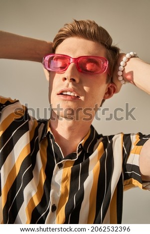 Fashion photo of a boy wearing trendy accessorizes Royalty-Free Stock Photo #2062532396
