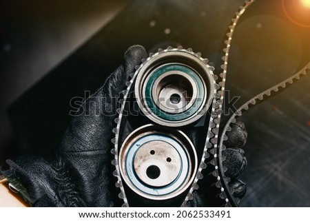 timing belt and tension rollers of the gas distribution system of the car engine, the concept of car maintenance Royalty-Free Stock Photo #2062533491