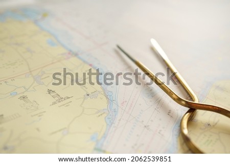 Antique W HC 6" brass dividers calipers nautical navigation chart tool and white map close-up. Vintage still life. Sailing, travel accessories. Planning, concept art, graphic resources, copy space Royalty-Free Stock Photo #2062539851