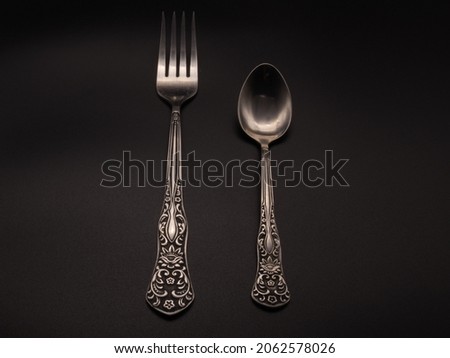 Spoon, fork on a dark background. High quality photo
