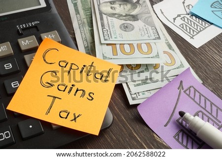 Capital gains tax is shown on a business photo using the text