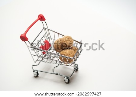Corks with mini cart supermarket on white background. Concept of delivery, online shopping. Copy space. High quality photo Royalty-Free Stock Photo #2062597427