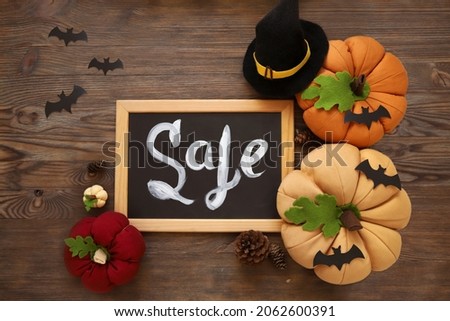 DIY Halloween crafting, handmade crafts for Halloween , spider, bat, felt witch hat and pumpkin made of fabric and felt. wood background with frame for your text. Top view with copy space for text