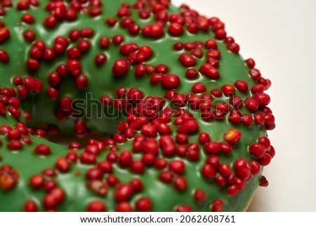 Green glazed round donut isolated on white background. Side view. High quality photo Royalty-Free Stock Photo #2062608761