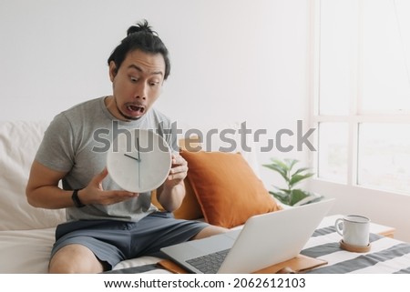 Shocked face asian man can not finish work by the deadline.