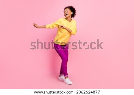 Photo of charming shiny woman dressed yellow sweater smiling dancing isolated pink color background