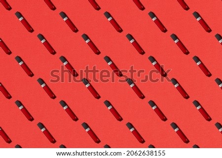 seamless pattern of red lipstick flat lay on the red background