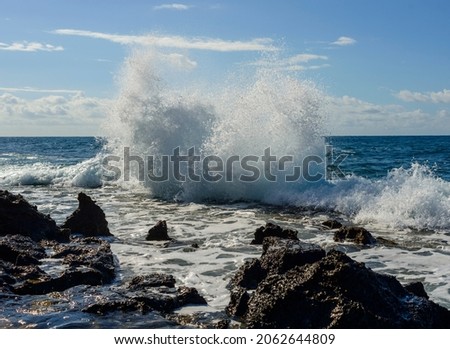 unique patterns painted by the splash of sea waves against the backdrop of the Mediterranean Sea, blue sky and white clouds
