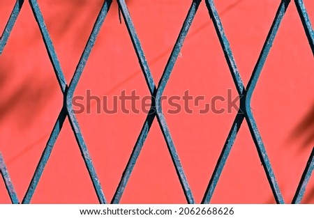 Blue mesh detail, rhombus grid on red background Royalty-Free Stock Photo #2062668626