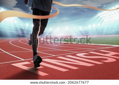 Runners running towards the finish line. Success concept. Royalty-Free Stock Photo #2062677677