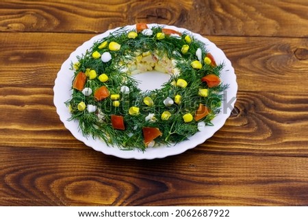 Salad Christmas wreath on a wooden table
